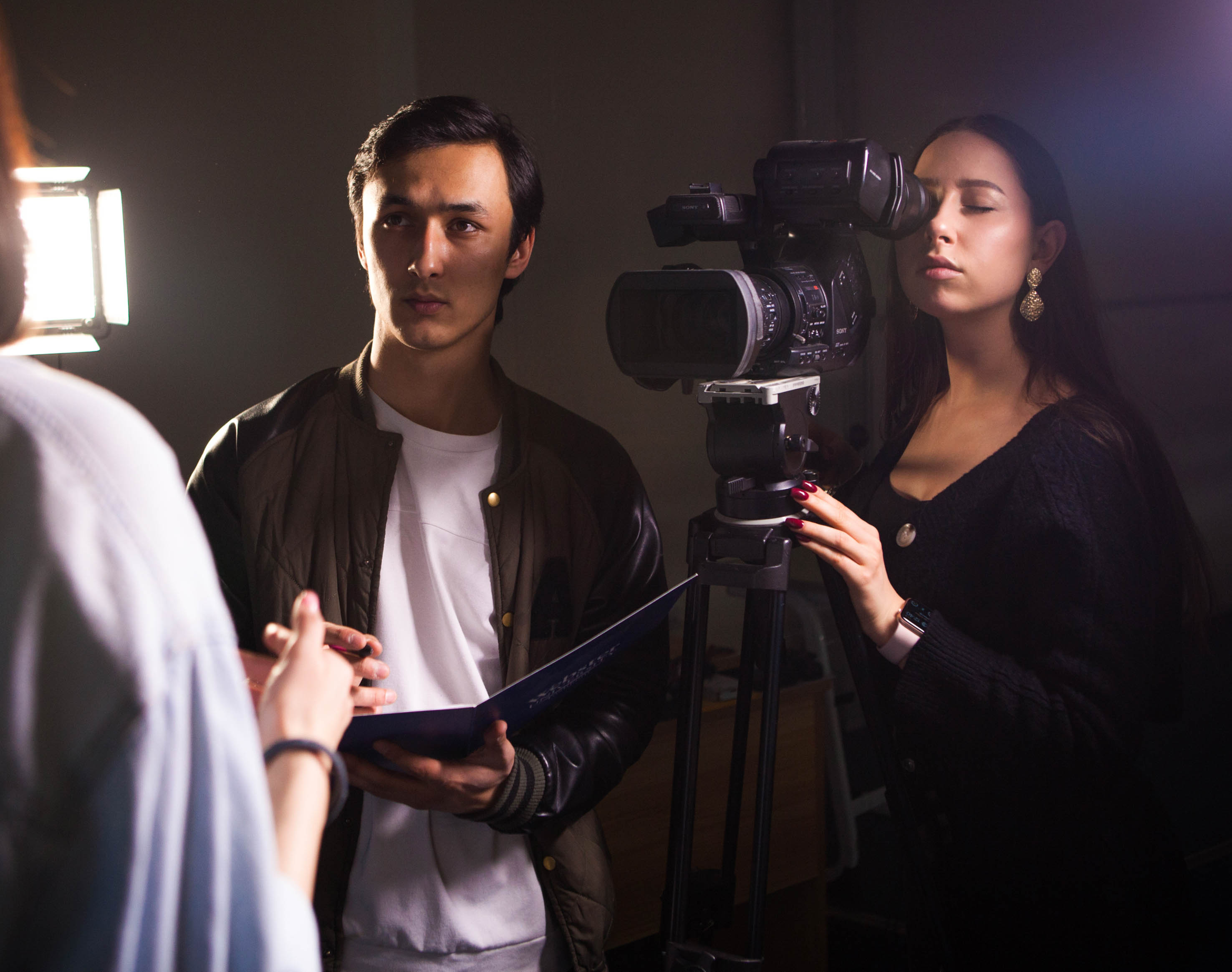Students practicing shooting interviews on video.
