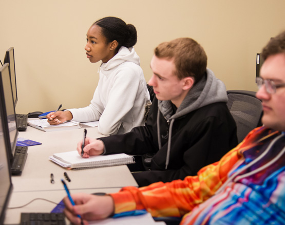 Students in classroom facing the front of the room. 