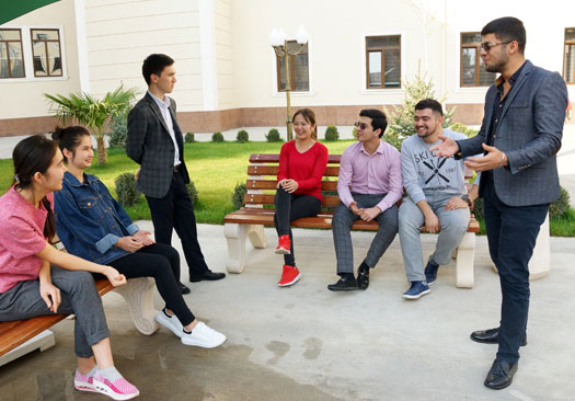 Students outside on Tashkent campus, talking