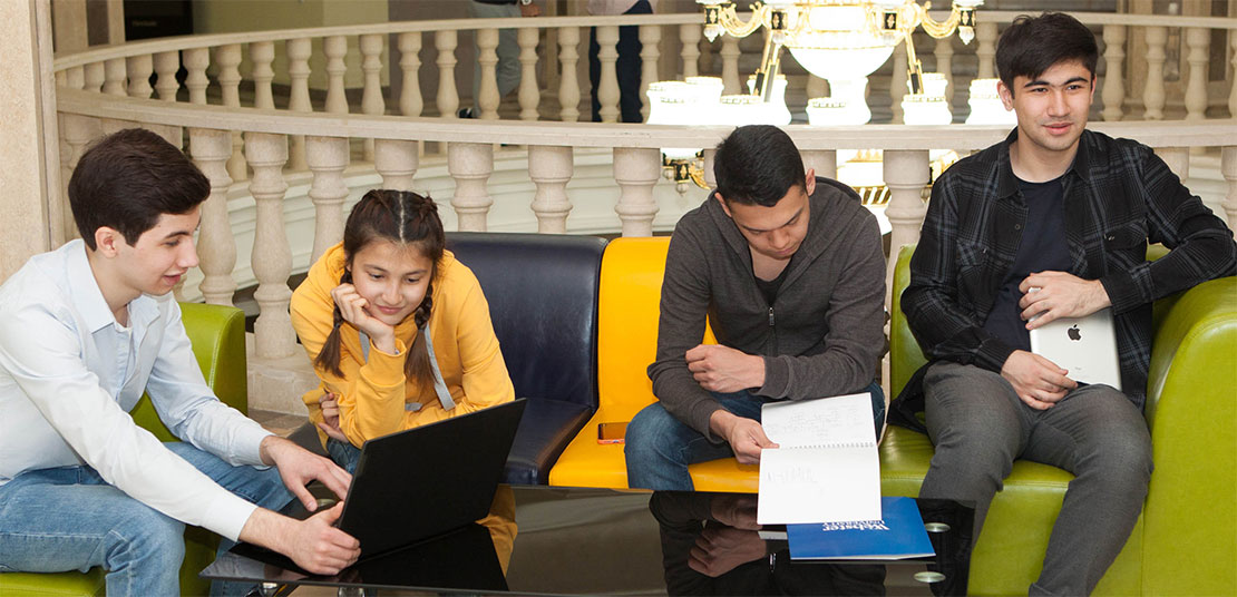 Students sitting on couches talking, studying